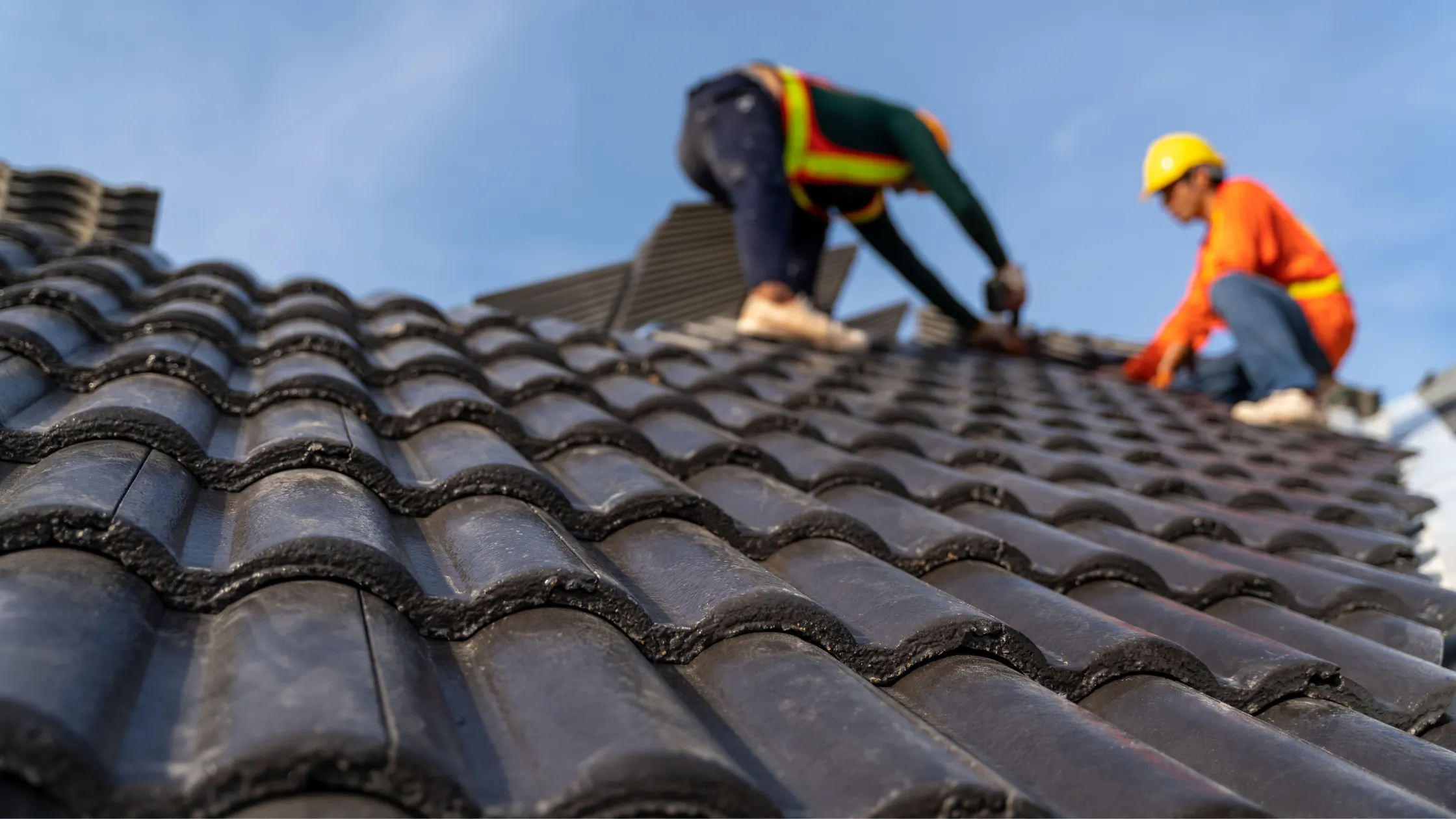 A roofing crew repair broken tiles in Phoenix